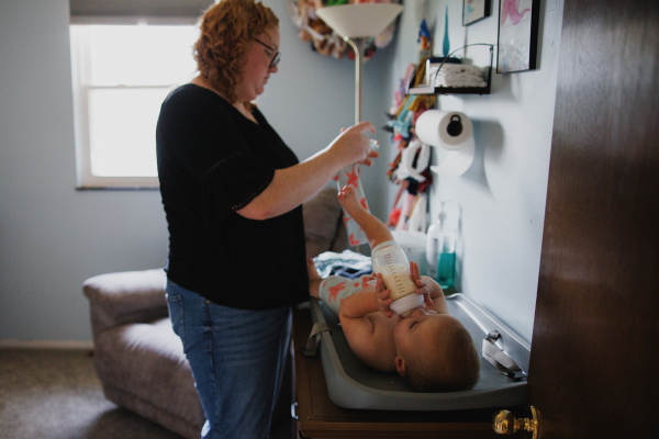 Ellie Currence gets Annalise ready for bed at their home in Belton, Missouri on July 17.