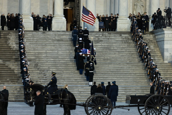 The flag-draped casket of former President Jimmy Carter travels in a horse-drawn caisson to the U.S. Capitol to lie in state in Washington, D.C., on Jan. 7.