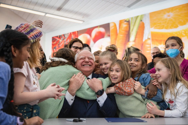 Students celebrate with Gov. Tim Walz after signing the free school meals bill at Webster Elementary in northeast Minneapolis on Friday, March 17, 2023.