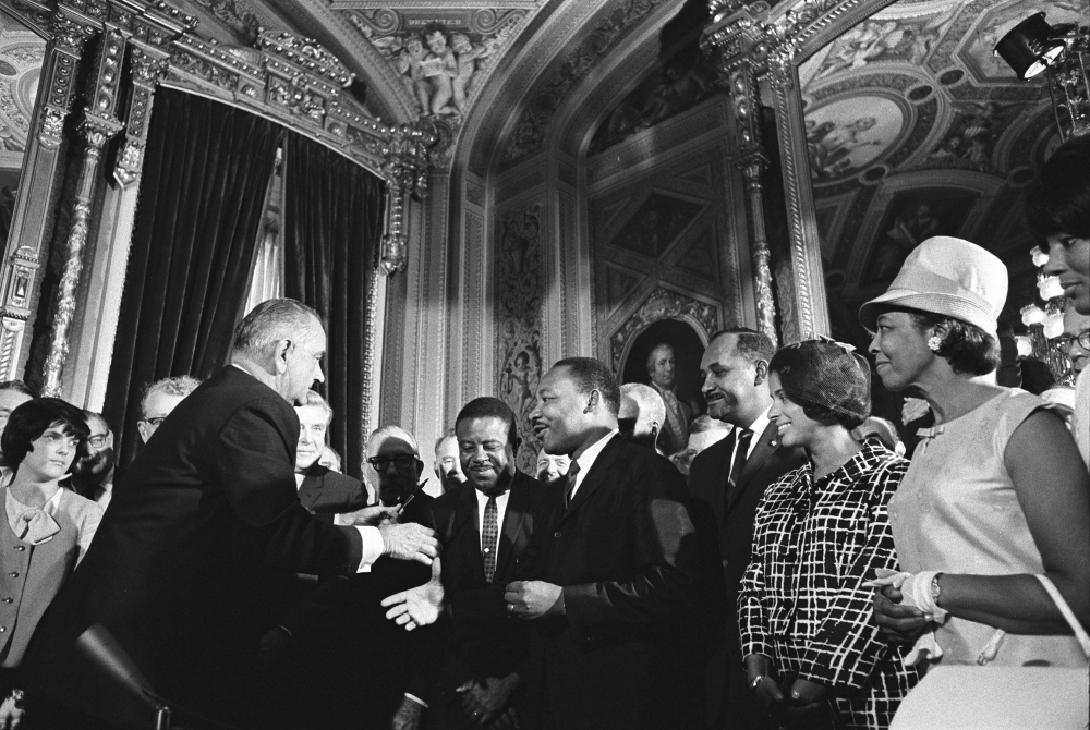 President Lyndon B. Johnson moves to shake hands with Martin Luther King Jr. while others look on after Johnson signed the federal Voting Rights Act into law at the U.S. Capitol in Washington, D.C., on Aug. 6, 1965. (Lyndon B. Johnson Library)