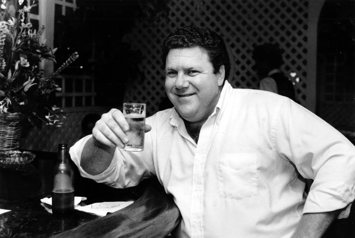 Actor George Wendt holds a glass of beer in a barroom in Los Angeles, Calif., on June 13, 1983.