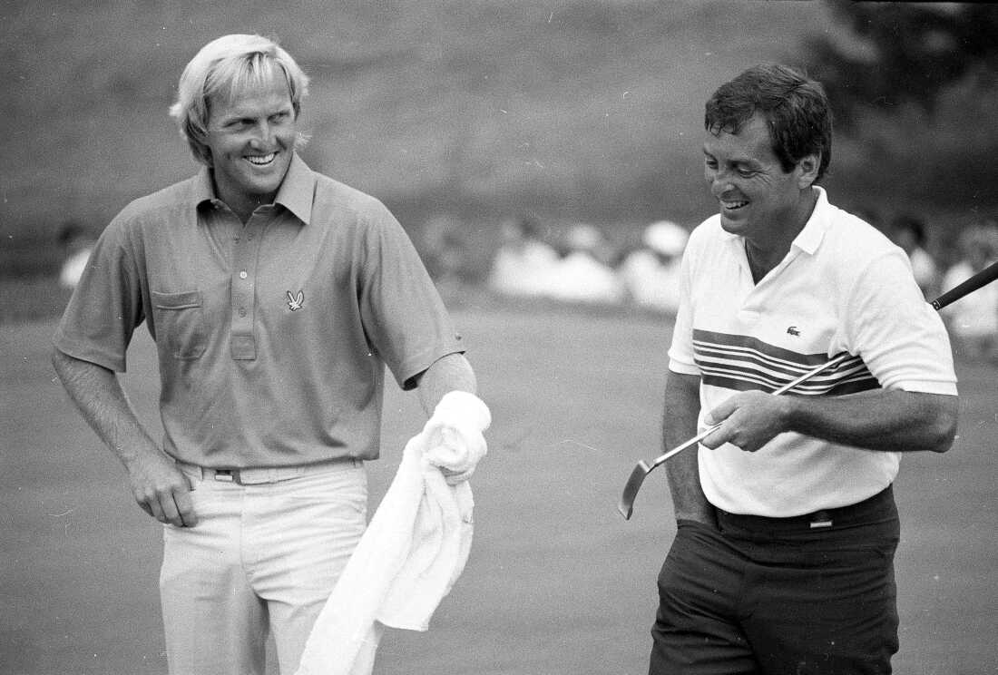 In this June 18, 1984 file photo, Greg Norman (L) holds a towel out toward Fuzzy Zoeller (R) as they walk down the 18th fairway together at Winged Foot Golf Club in Mamaroneck, N.Y. during a playoff for the U.S. Open Championship.