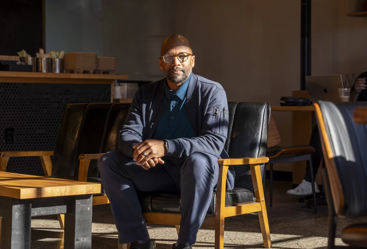 Imam Mika'il Stewart Saadiq sits inside Kitab Cafe in Detroit on Oct. 10. He is one of 25 American imams from across the country who endorsed Harris in an open letter.