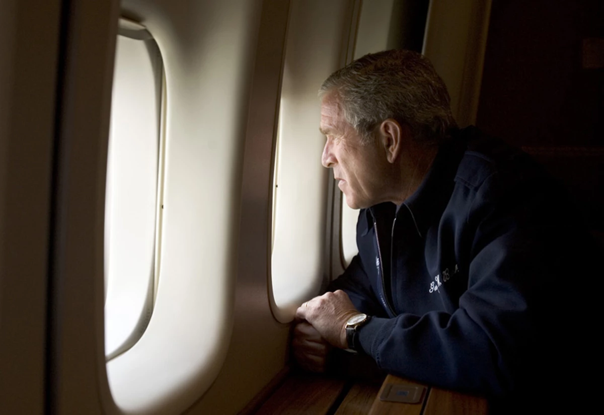 President George W. Bush looks out over devastation from Hurricane Katrina as he heads back to Washington D.C. Aug. 31, 2005 aboard Air Force One.