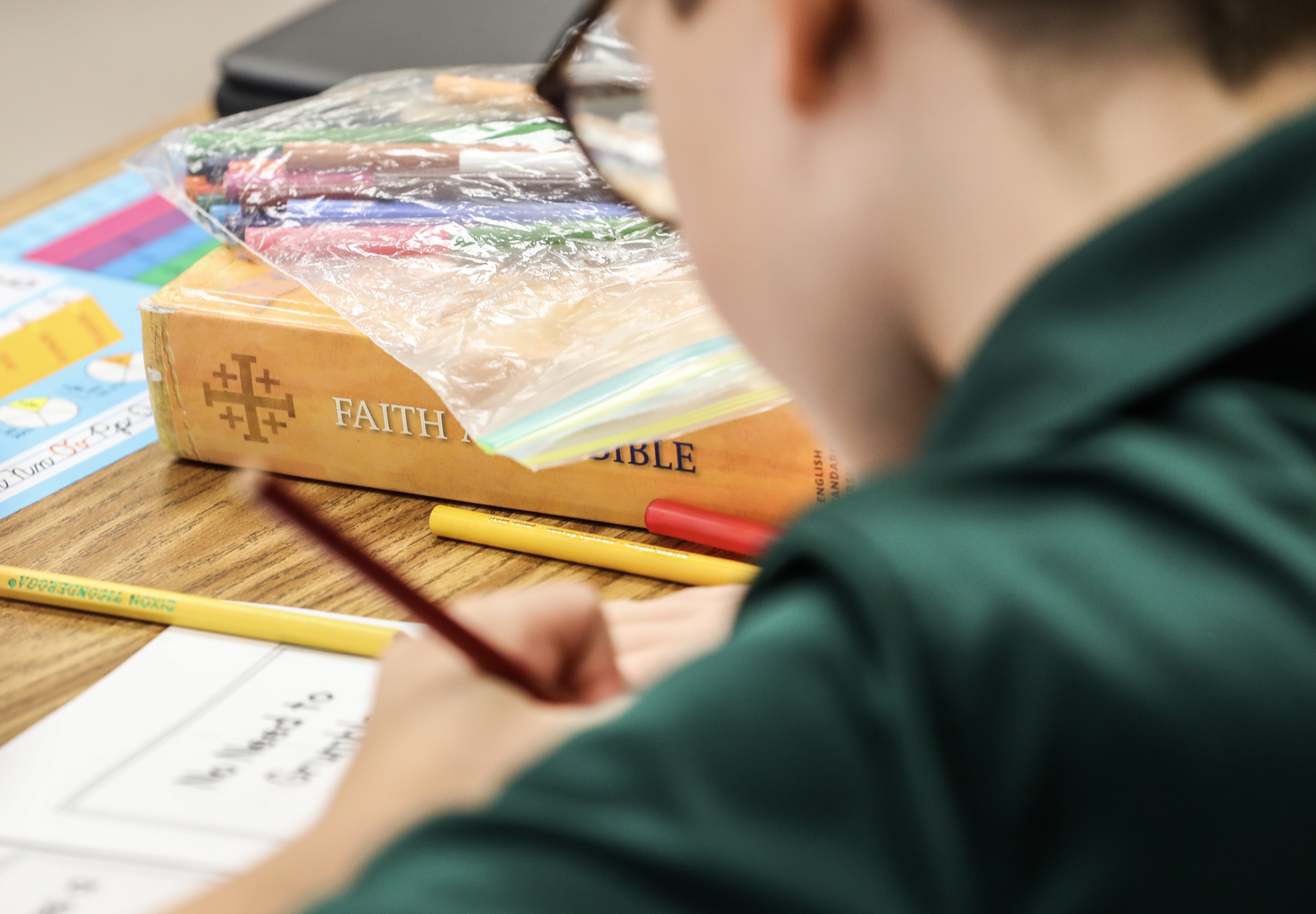 A private school student works on a lesson at St. Luke