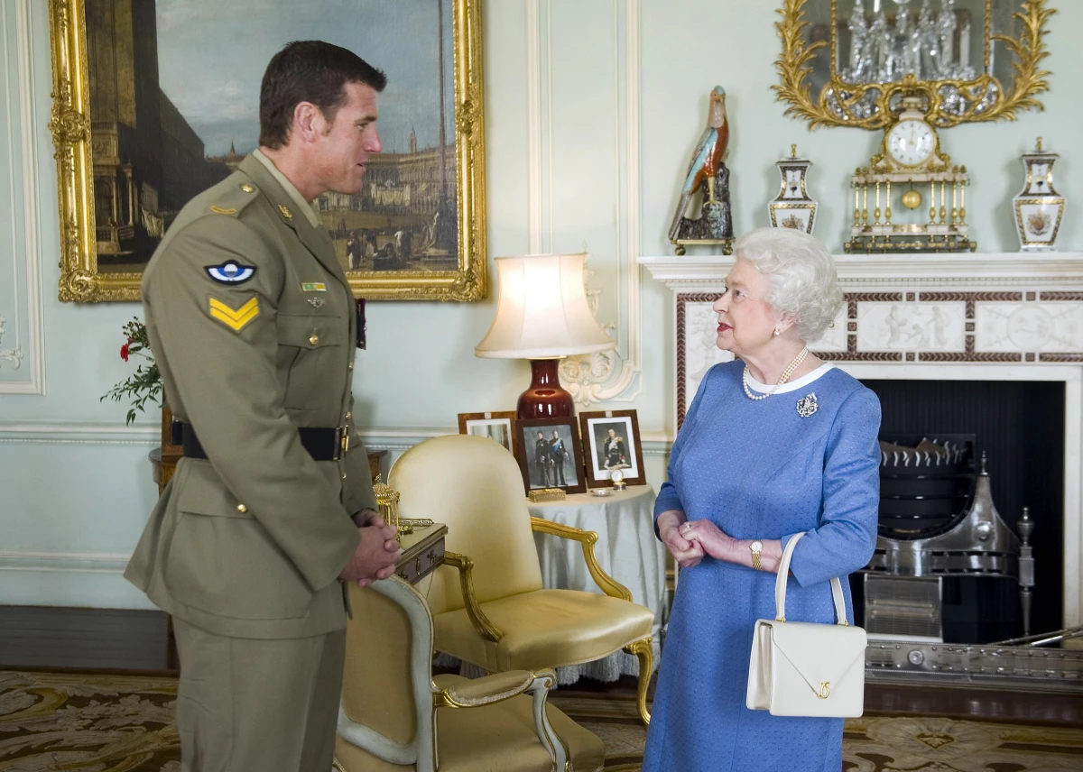 FILE - Britain's Queen Elizabeth II greets Corp. Ben Roberts-Smith from Australia, who was recently awarded the Victoria Cross, during an audience at Buckingham Palace in London, Nov. 15, 2011.