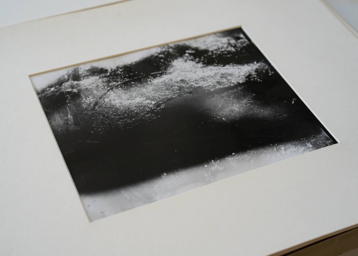 A print from Sally Mann's new series focused on the James River and Point Comfort, placed on a table in her studio. Mann accidentally solarized the image when she turned on her phone in the corner of the dark room during the specialized film's long development process.