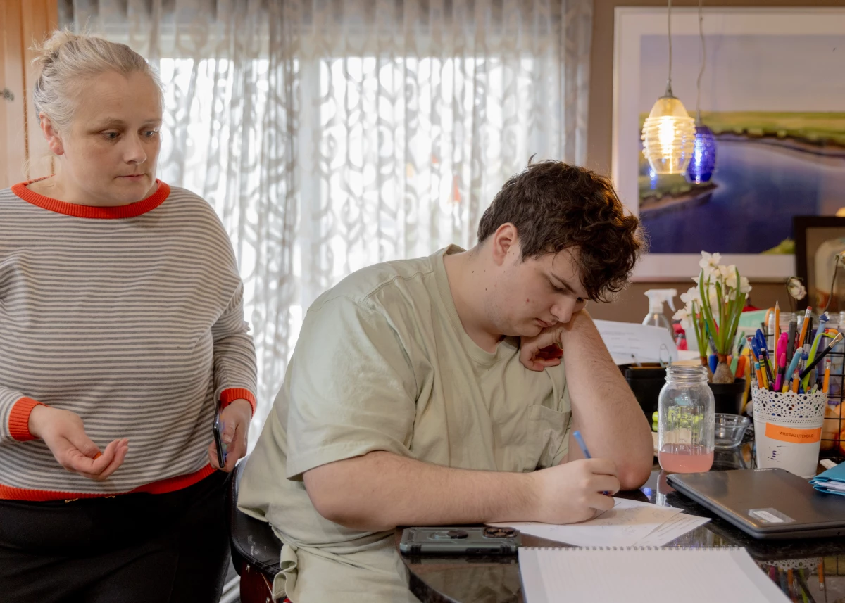 Logan works on his geometry homework before a home-based tutoring session.