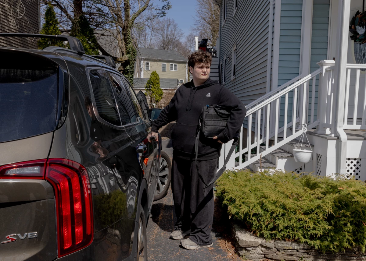 Logan heads to school, sometimes by bus and sometimes driven by his mother.
