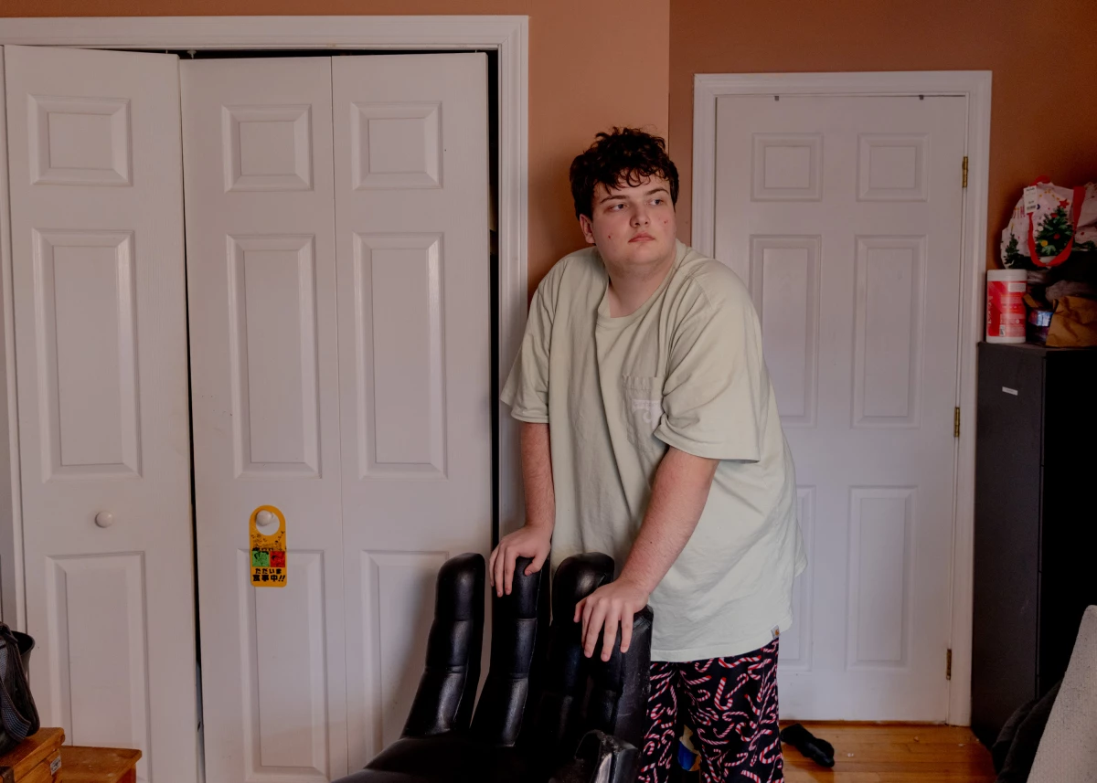 Logan, 17 and a junior at Newton South High School, stands in his room in Newton, Mass. Logan was part of a program called Charting My Path, which helps students with disabilities prepare for life after high school. The Trump administration cancelled the program in February.