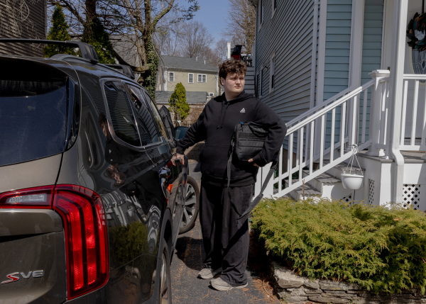 Logan heads to school, sometimes by bus and sometimes driven by his mother.