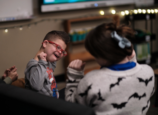 Kellen dances to a song with a classmate.