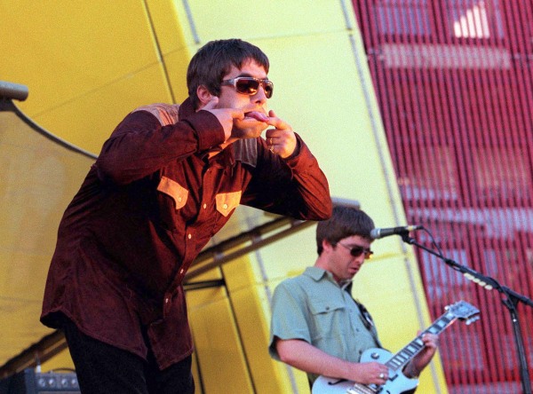 Singer Liam Gallagher (L) and brother Noel Gallagher of band Oasis perform on stage in San Francisco in 1997.