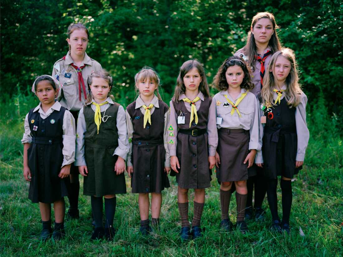 A group of “novachky” (female campers ages 6-11) stand at attention for a photograph, along with their two “sestrichky” (female counselors, translating to Sisters in English), as marching drills are part of daily activity at camp.