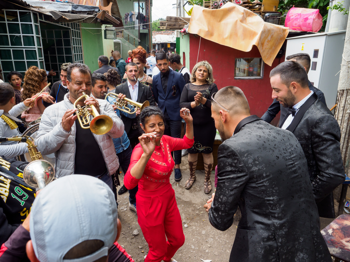 Members of the Roma community in Sofia, Bulgaria, celebrate at a wedding, with musicians entertaining the guests.