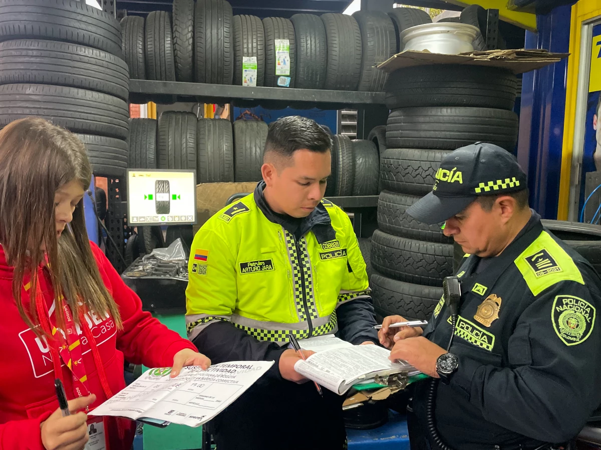 Police officers temporarily shut down a tire-repair shop in Bogotá, Colombia, on June 26.