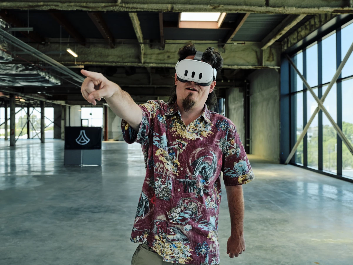 Luckey puts on a virtual reality headset to show an augmented reality model of Anduril’s Dive-LD underwater drone at Anduril headquarters.