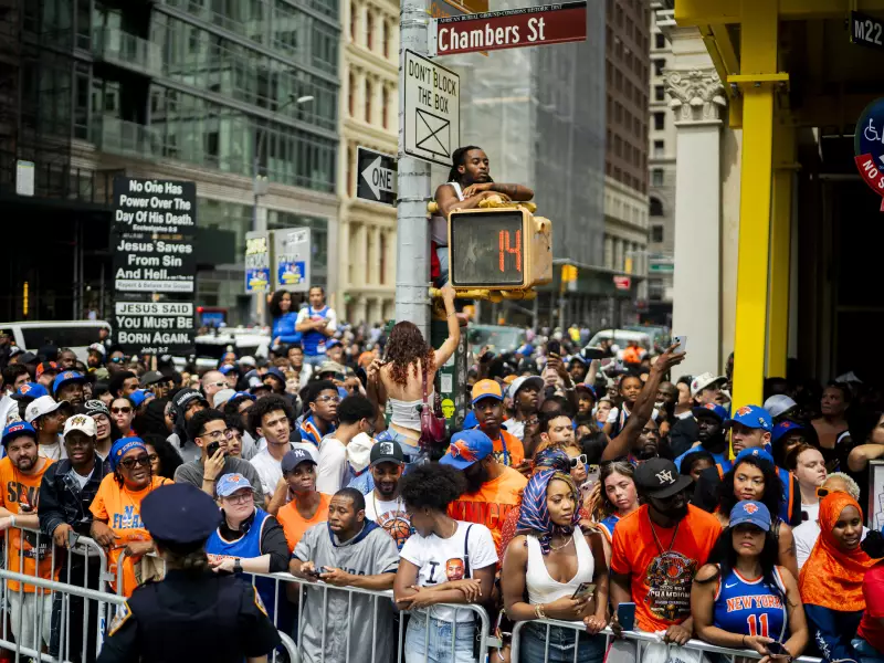 New York Knick fans celebrate winning the 2026 NBA Championship with a ticker tape parade at City Hall.