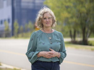 Juli Briskman, a member of Loudoun County's Board of Supervisors, stands along the street in front of the Vantage VA2 data center in Sterling.
