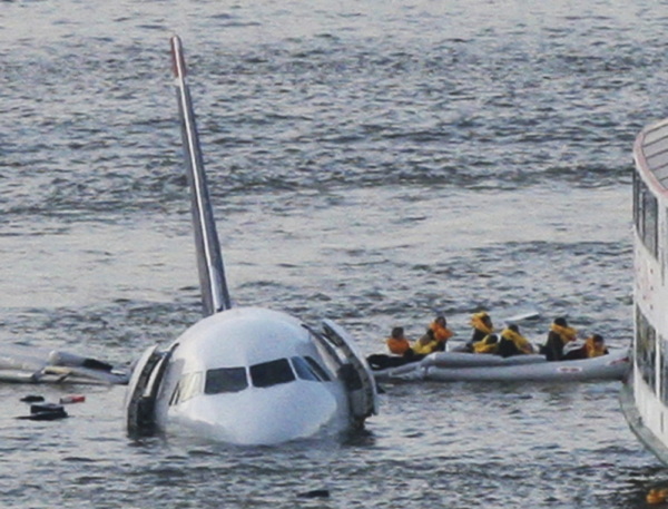 In this Jan. 15, 2009 file photo, passengers in an inflatable raft move away from US Airways Flight 1549 that went down in the Hudson River in New York. The passenger jet survived a bird strike and crash landing.