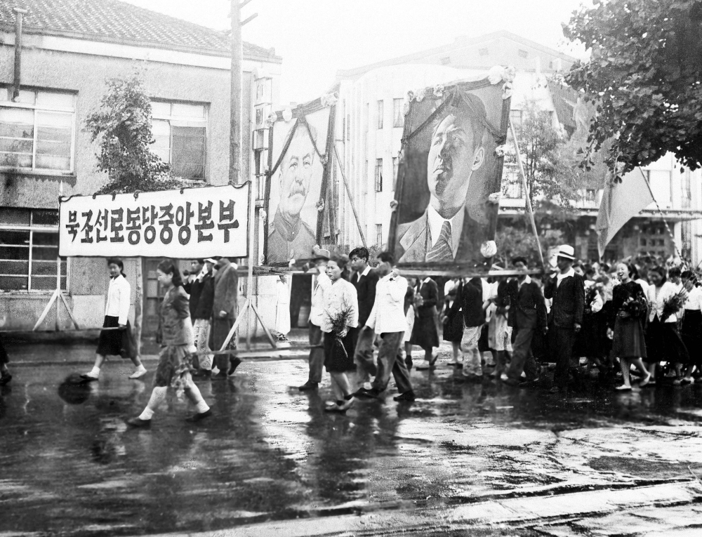 Part of a welcome for the United States-Soviet commission on Korea on their arrival in Pyongyang on July 23, 1947, was this parade of Korean communists carrying huge portraits of Josef Stalin and Kim Il Sung. The commission visited Pyongyang, 165 miles north of Seoul, for the purpose of getting views of political groups on the prospecting. (AP)