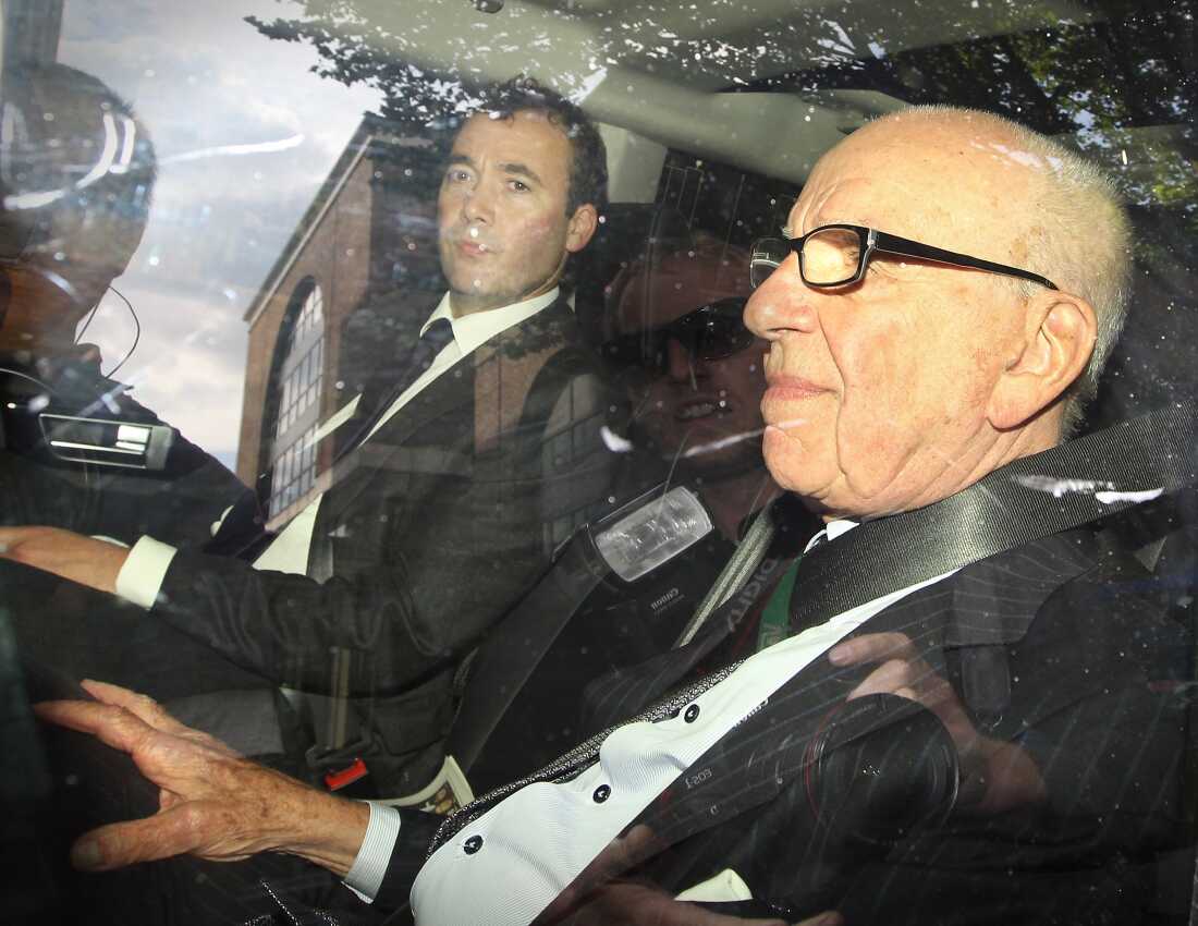 Will Lewis, left, accompanies Rupert Murdoch — his boss at the time — on July 15, 2011 in London, England. The company was embroiled in a massive phone hacking scandal at the time.