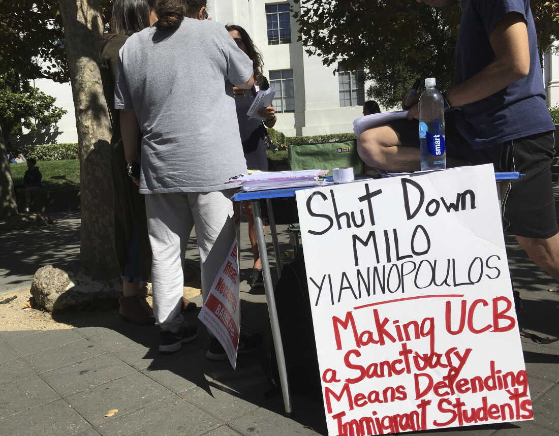 In this Sept. 21, 2017 photo, a group has put up flyers and a booth on Sproul Plaza calling for protesters to "Shut Down Milo Yiannopoulos," at the University of California, Berkeley campus in Berkeley, Calif.