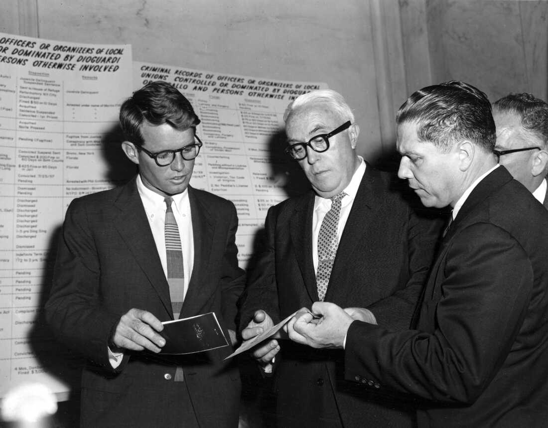 In this file photo from 1957, Robert Kennedy, left, counsel for the Senate Rackets Investigating Committee, attorney George S. Fitzgerald, center, and his client, Teamster Union Vice President James R. Hoffa, confer during a break in hearings in Washington, D.C., in Sept. 1957.