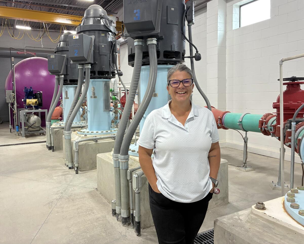 Shari Whalen, general manager of the TRI General Improvement District, stands near pumps inside the district's water reclamation facility.