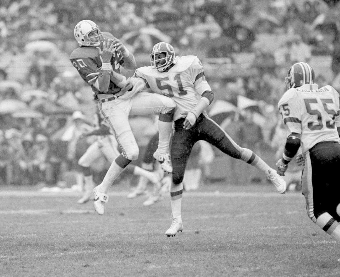 New England Patriot Don Hasselbeck fights to hold on to a pass as Washington Redskin Monte Coleman tries to shake the ball loose, Oct. 25, 1981.
