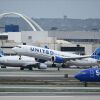 A United Airlines Boeing 737 MAX 9 airplane passes a Southwest Airlines Boeing 737 while taking off from Los Angeles International Airport (LAX).