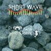 Blue-gray lumps that structurally resemble coal under a white logo that reads "Sea Camp" and has a white cartoon image of waves, bubbles, a crab and a seahorse. The top logo in white reads "Short Wave"