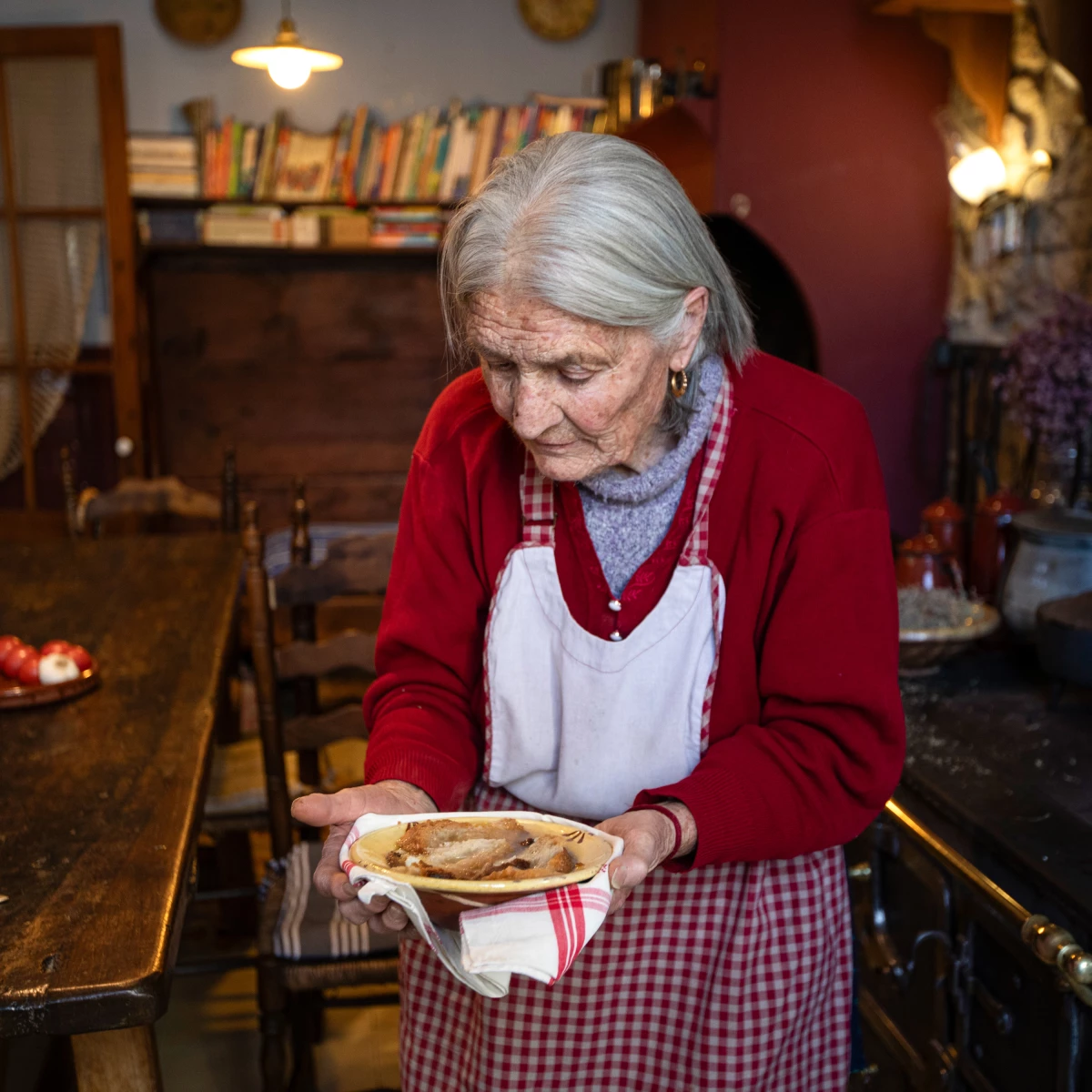 Angela Farre Palacin holds the soup she just prepared in the kitchen of Casa Leonardo, an inn that has been in the family for three generations and that serves traditional Catalan cuisine to its guests.