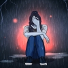 Depressed teenage girl sitting alone in the rain.