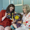 Should states force cities to build cheaper houses? Voters here will decide 20 Stacia Bourne; her mother, Mary Jo Galusha; and Bourne's child are sitting on a sofa at Galusha’s home in Newark, Delaware. The child is sitting between the two women, and Bourne is holding up a children's book as the three enjoy it together.