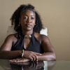 Herlain, who asked NPR to withhold her last name, poses for a portrait at her home in North Lauderdale, Fla.
