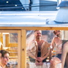 Sauna enthusiast Michael Calcagno, second from right, sits inside a clear-walled wood-fired sauna during the Seattle Sauna Festival in November. Sauna use has taken off as a health practice and scientists are studying its benefits.