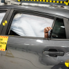 A crash-tested vehicle sits in the test hall, with airbags deployed and a crash test dummy's hand visible in the rear window, after a moderate overlap frontal crash test at the Insurance Institute for Highway Safety in Ruckersville, Va., on Tuesday, Dec. 2, 2025.