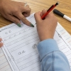 Teacher Sherisse Kenerson helps a student during after-school cursive club at Holmes Middle School in Alexandria, Va.