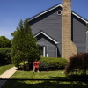 Kimberly Holmes-Ross sits on a bench on a grassy yard outside her home in Evanston, Illinois.