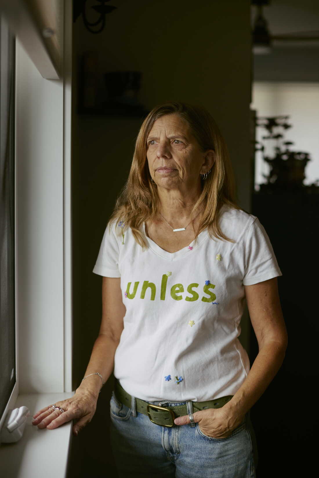 Daryl McCool poses inside her rebuilt home in Superior, Colorado. Her previous home was destroyed in the Marshall Fire, which swept through Superior and Louisville on Dec. 30, 2021. T