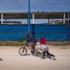 Children ride a bicycle and play in the Roj camp in Northeast Syria in March.
