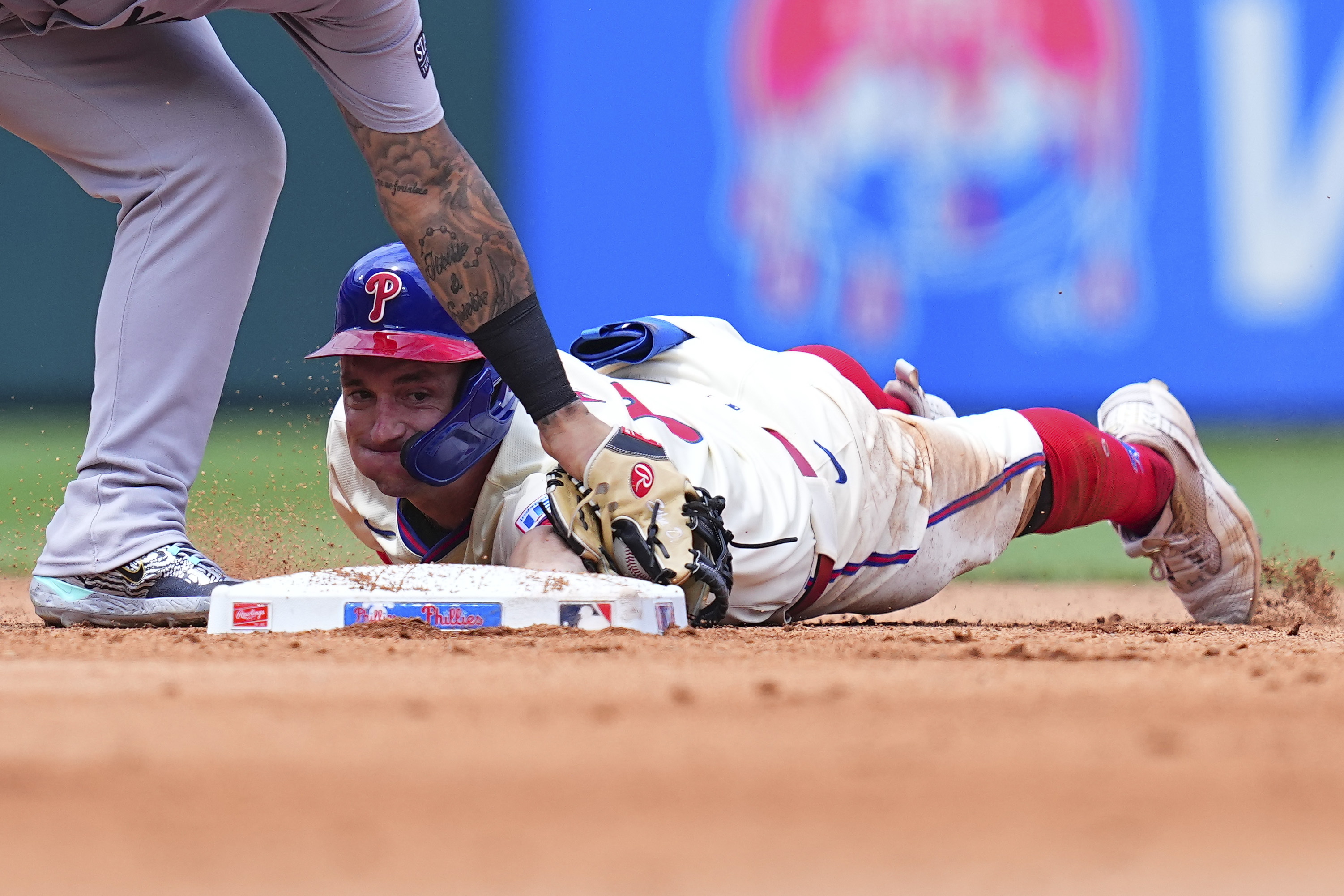Austin Hays of the Philadelphia Phillies slides in safely past Gleyber Torres of the New York Yankees on July 31, 2024. The Yankees defeated the Phillies 6-5 that day.