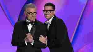 Hosts Eugene Levy and Dan Levy speak during the 76th Primetime Emmy Awards on Sunday at the Peacock Theater in Los Angeles.