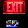 Seen on a screen below an exit sign, President Trump speaks on the first day of the 2026 Republican convention on Sept. 9 in Dallas.