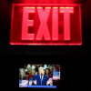 Seen on a screen below an exit sign, President Trump speaks on the first day of the 2026 Republican convention on Sept. 9 in Dallas.