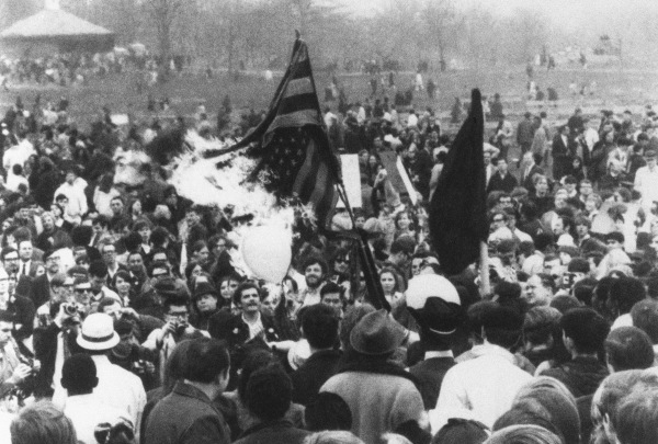 Anti-war demonstrators burn a U.S. flag after marching to the State House in Boston in 1971.