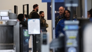 Immigration and Customs Enforcement agents work at the baggage check and security control x-ray area at O'Hare International Airport in Chicago on Tuesday.