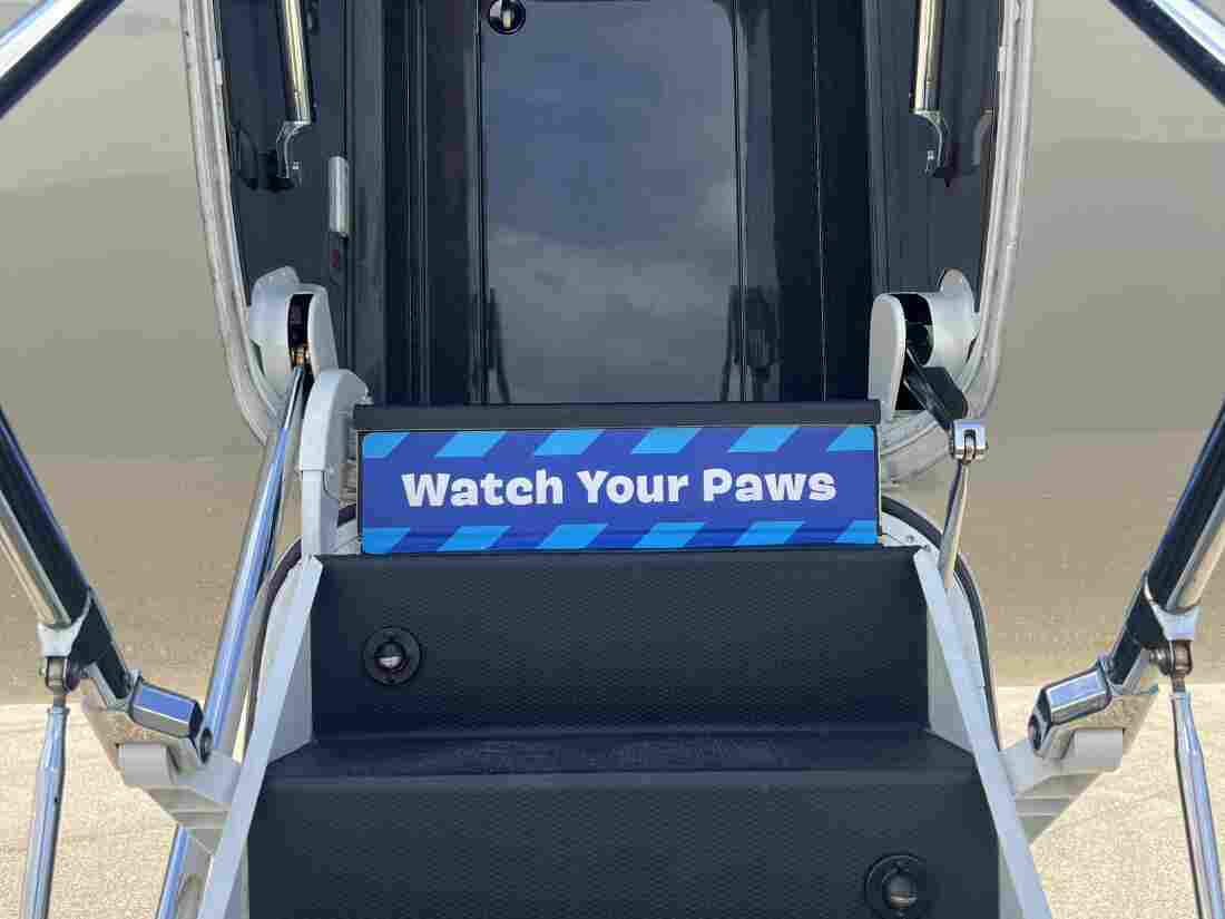 Stairs leading up to a plane, with a sign reading 