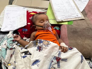 Six-month-old Sumaiya Saima needs oxygen support due to measles complications. The infant is in the measles ward at Shishu Hospital of Dhaka.